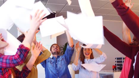 business colleagues throwing documents in the air