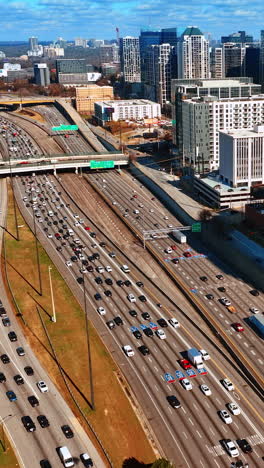 three wide-lane highways with lots of cars going by. panorama of atlanta, georgia, usa from top on sunny autumn day. vertical video