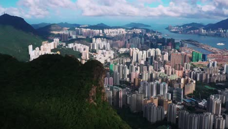 kowloon lion rock mountain peak overlooking downtown skyscraper business district hong kong aerial orbit left