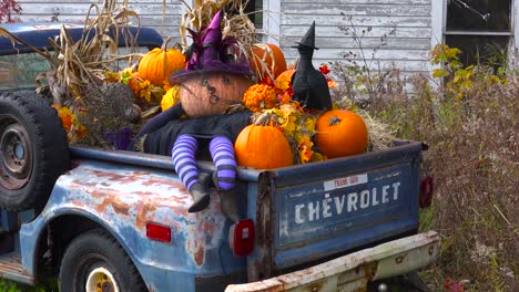 autumn or fall is welcomed in with a homemade halloween display in the back of a pickup truck