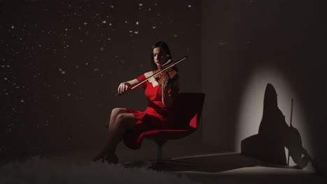 woman playing violin in red dress