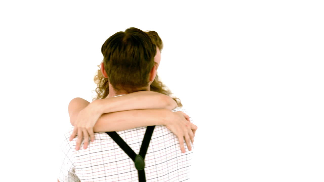 In slow motion geeky hipster couple hugging 