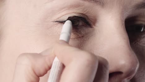 a european old woman doing makeup