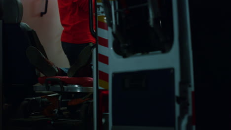 emergency doctor giving first aid help to patient. man lying on stretchers