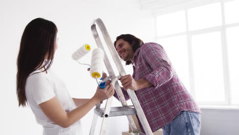 couple painting a room together