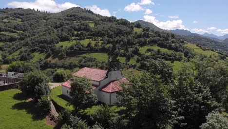 aerial panoramic landscape, romanesque church san vicente serapio asturias spain vast greenery, mountains and clear skyline