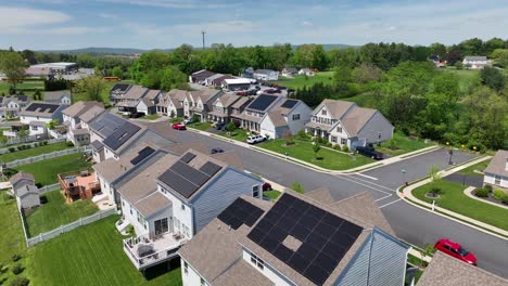 solar panels on roof of modern houses. american neighborhood during sunny day in spring. aerial view.