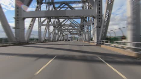 rear facing driving point of view pov on large modern girder bridge with multi-lane elevated freeway flyover on brisbane's story bridge - ideal for interior car scene green screen replacement