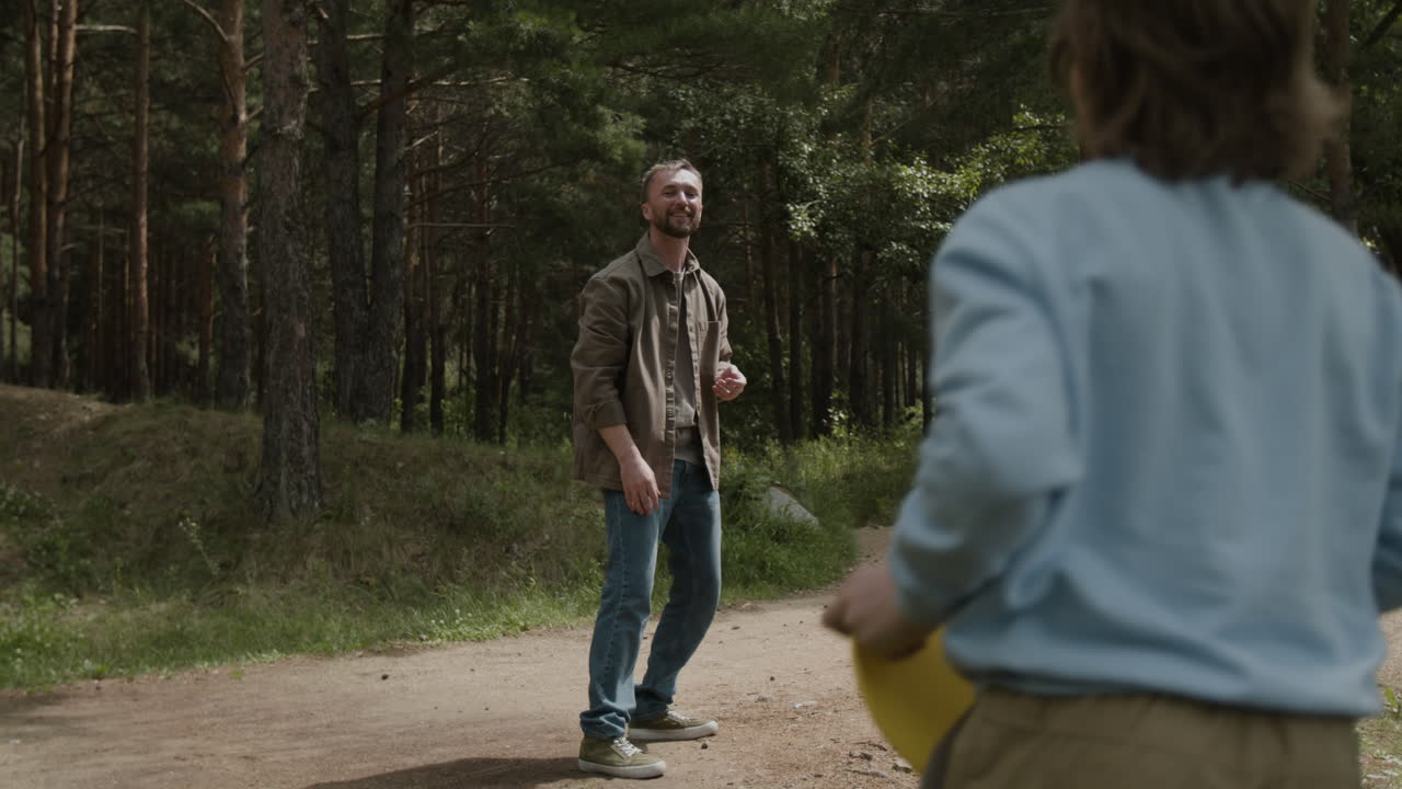 People playing frisbee in the forest