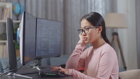 teenager coding on a computer