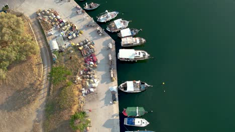 Small-Fishing-Port,-Aerial-View-of-Boats-Docked-in-Kavala-Perigiali-Greece