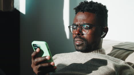 man using smartphone at home