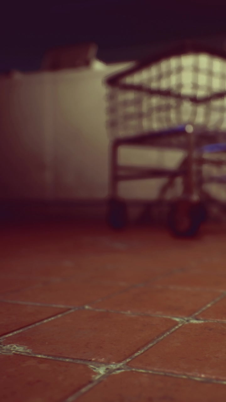 Floor and cart in a dim area with tiled surface during the evening