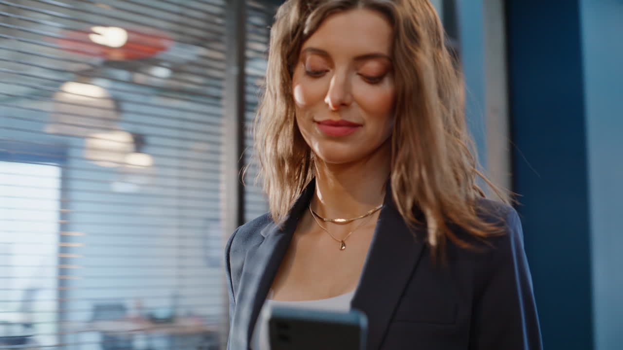 Entrepreneur going hall office looking smartphone closeup. Confident woman