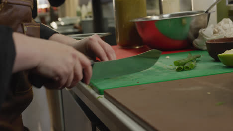 caucasian woman cutting vegetables