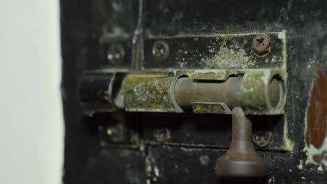 close up of a sliding bolt latch on a door