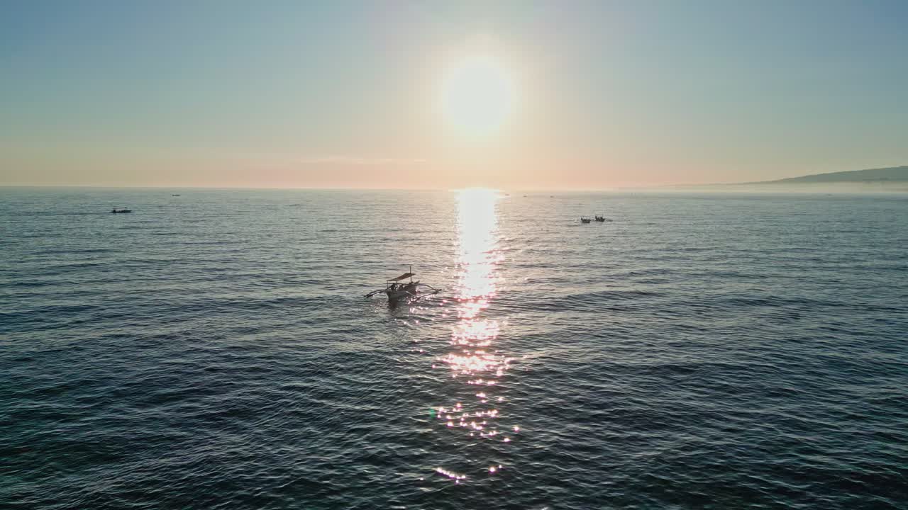 Fishermen’s wooden boats bring visitors close to wild dolphins under the morning light in Asia
