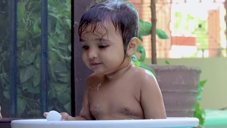 toddler enjoying bathing in tub at outdoor from unique perspective
