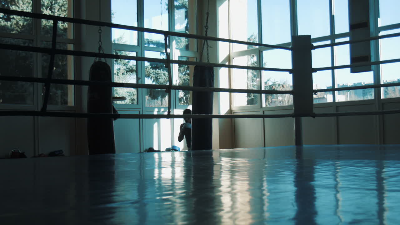 Silhouette Of Young Boxer Training With Punching