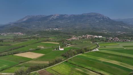 landscape of vipava valley, slovenia with a church and farmland, aerial shot