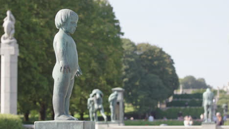 a sad looking young bronze child in vigeland sculpture park, oslo
