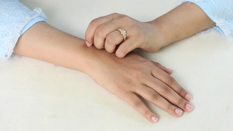 young women suffering from itching skin sitting on park ,