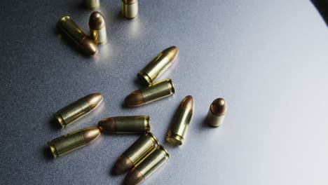 isolated bullets on a metallic table background, projectile ammo ammunition top down shot