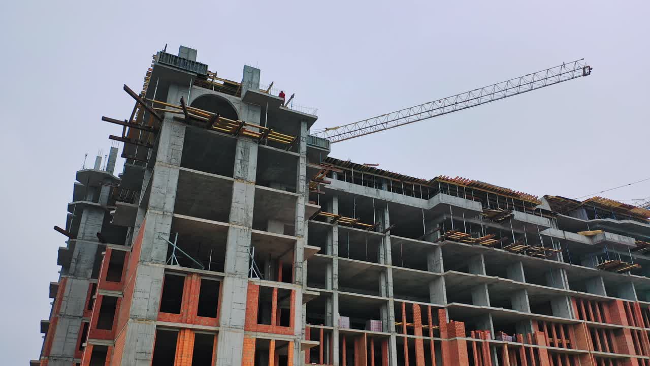 Construction of high-rise building. Front view of huge building in the process of construction. New construction site in the city.