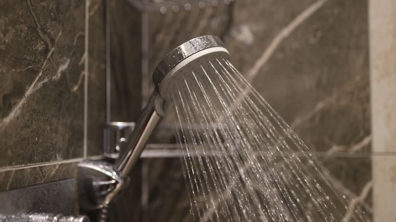 Close-up of a shower head with running water