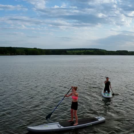 people relaxing on paddle sup board