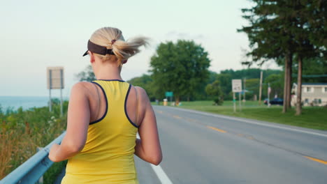 middle-aged woman runs along the road in a typical suburb of the united states a healthy lifestyle s