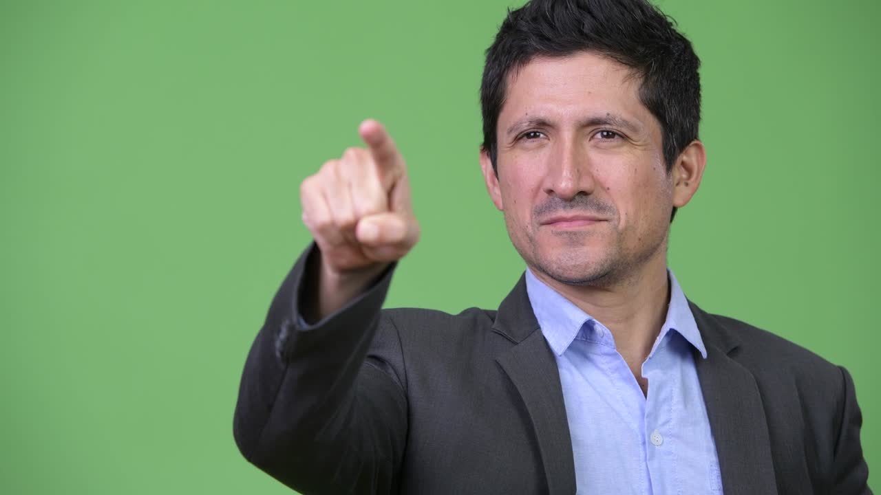 Happy Hispanic businessman pointing finger