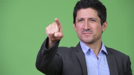 happy hispanic businessman pointing finger