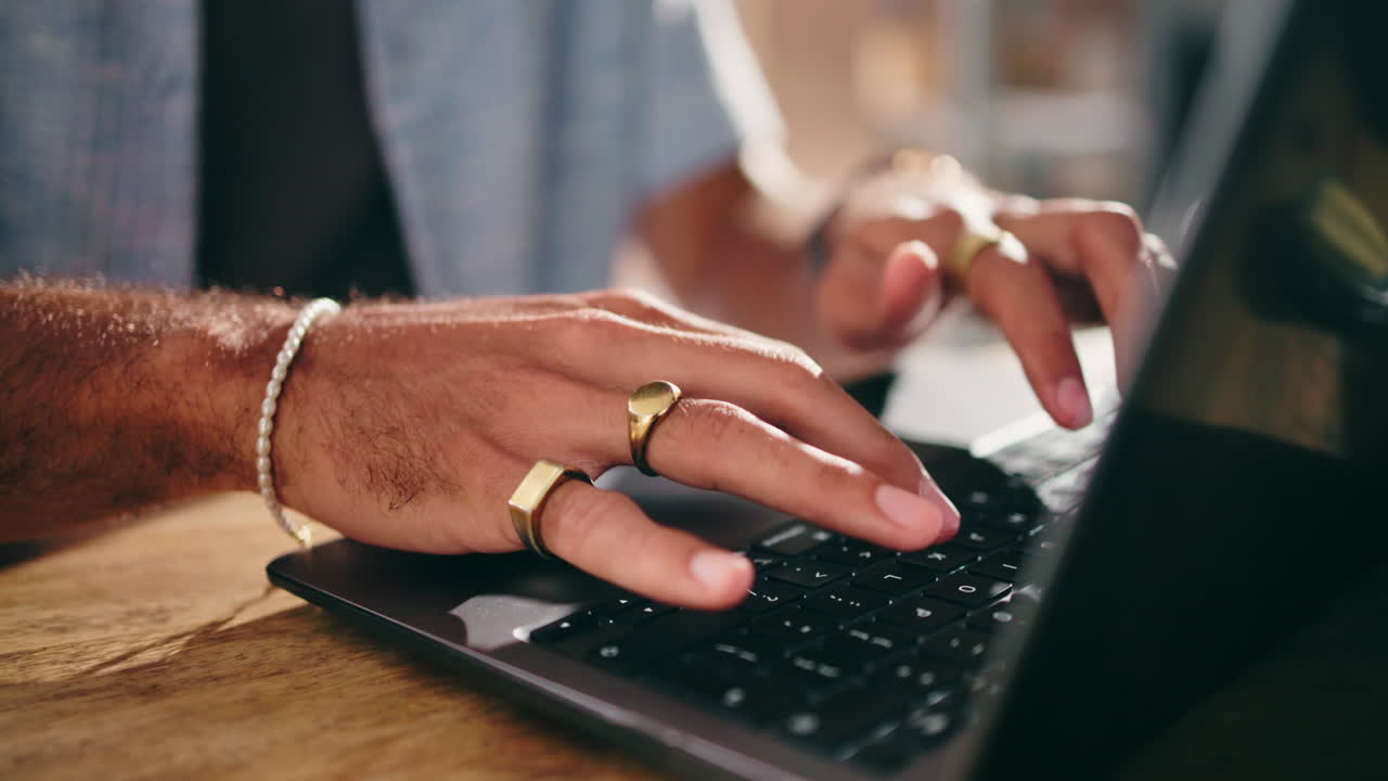 Close Up of Man's Hands Typing on Laptop Keyboard