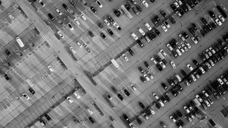 dynamic timelapse shows riga parking lot in motion from top-down grayscale view