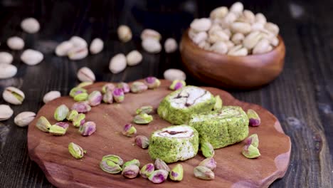 put fresh turkish delight with crushed pistachios and chocolate on a board