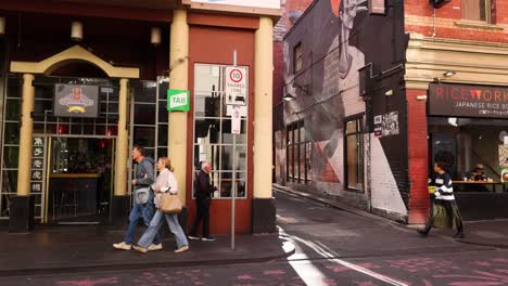 pedestrians walking past a chinatown building