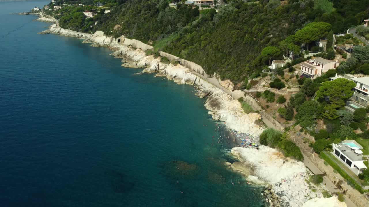 Aerial view of a rocky coast with vegetation and houses