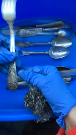 cleaning silverware with gloves