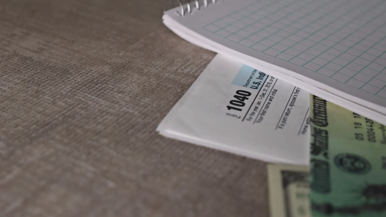 Stimulus economic tax return check and US 100 dollar bills currency