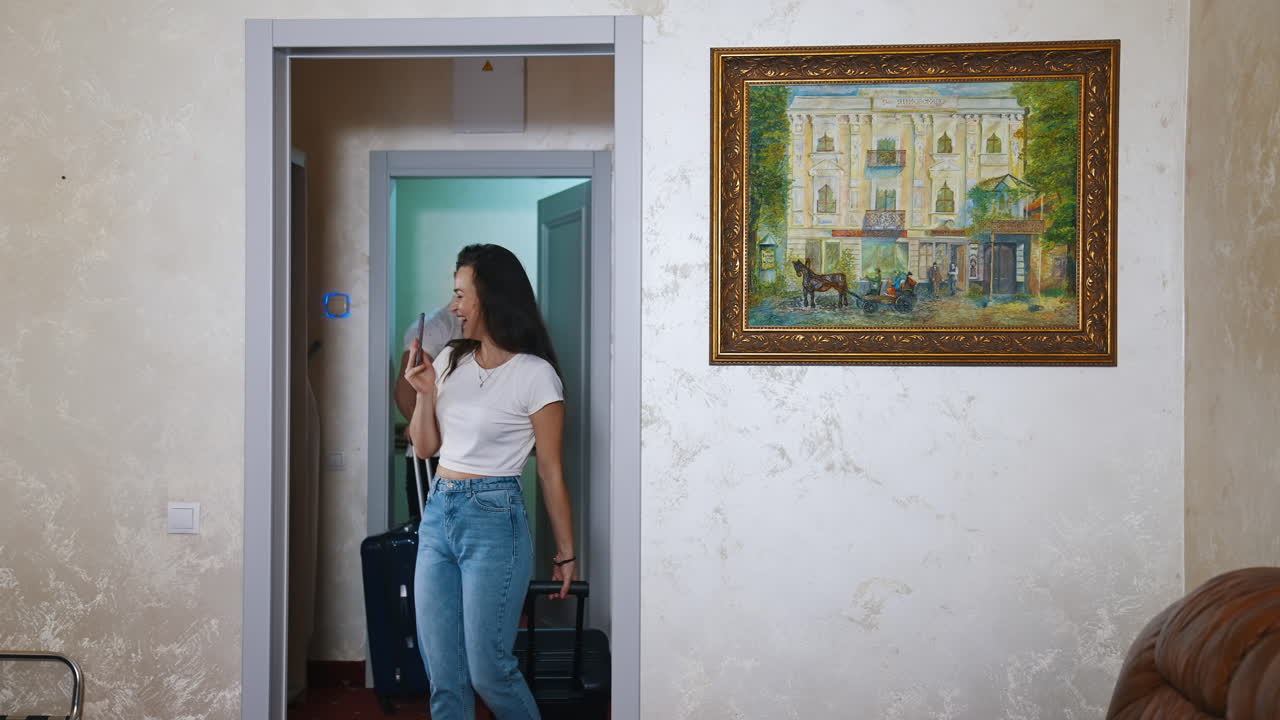 Young couple entering hotel room. Young happy couple on vacation in hotel room