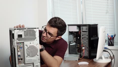 concentrated computer service worker repairing a broken computer in the office and upgrading computer hardware. support team. computer maintenance. shot in 4k