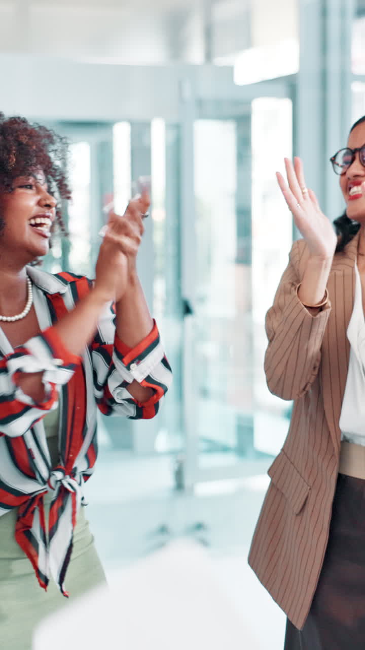 Two Happy Businesswomen Celebrating Success by Throwing Papers in Office