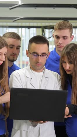 a doctor analyzes data in a gym showcasing teamwork in fitness in a gym individuals gather around a doctor analyzing data on a laptop the collaborative atmosphere highlights teamwork and innovation in fitness