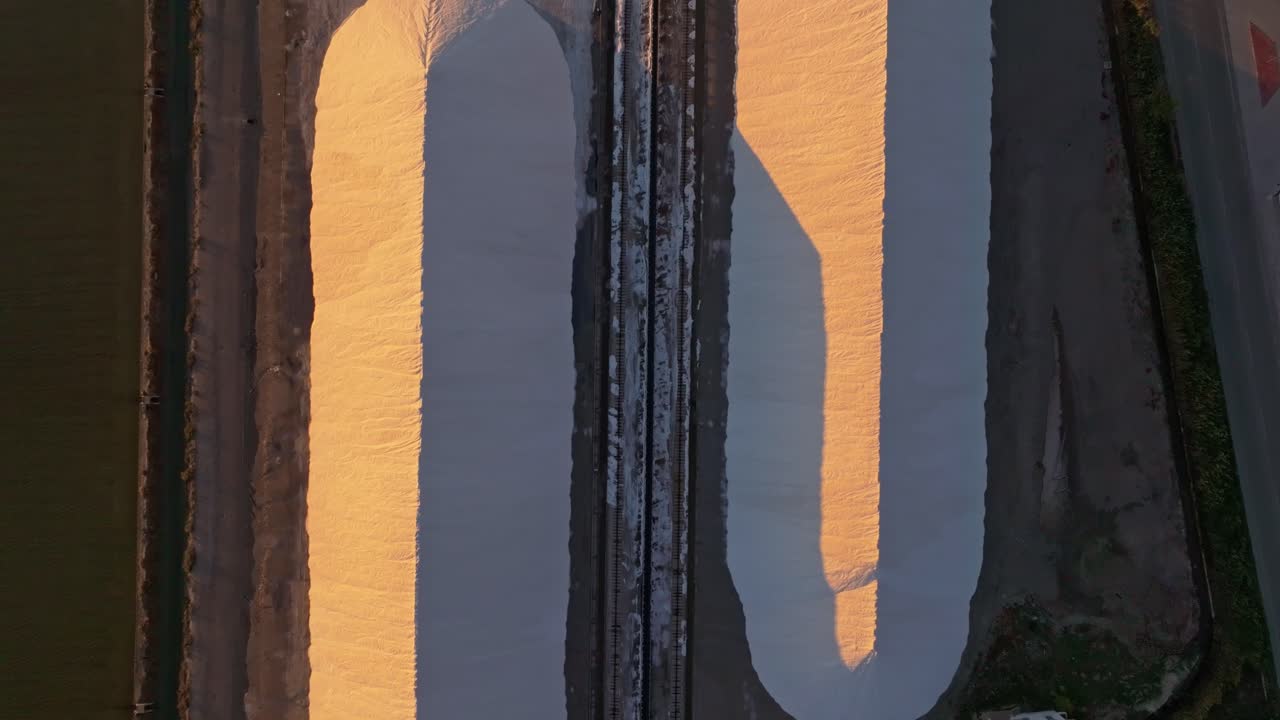 Evening drone view of working salt fields and plant, Aitoliko, Greece