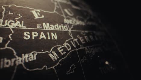 close-up of a vintage world globe highlighting spain and the mediterranean region