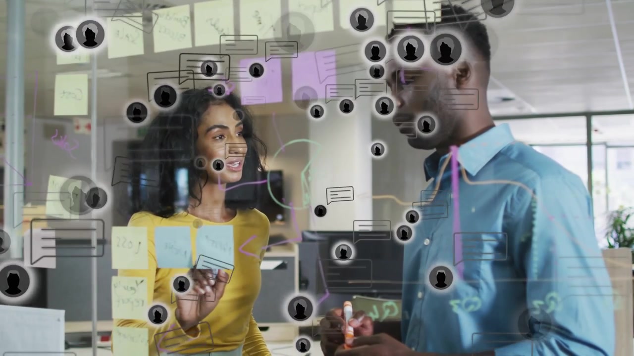 Woman tapping notes, man holding pen on glass planning wall, business plan with chat icons overlay