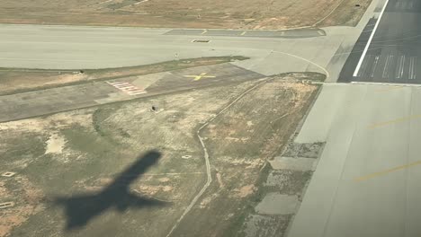 shadow of a jet on the ground during a real time landing as seen from the cockpit