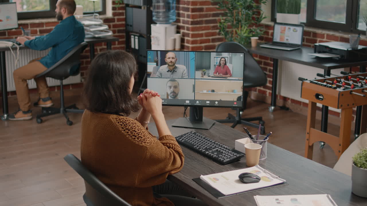 Woman participating in a video conference in a modern office
