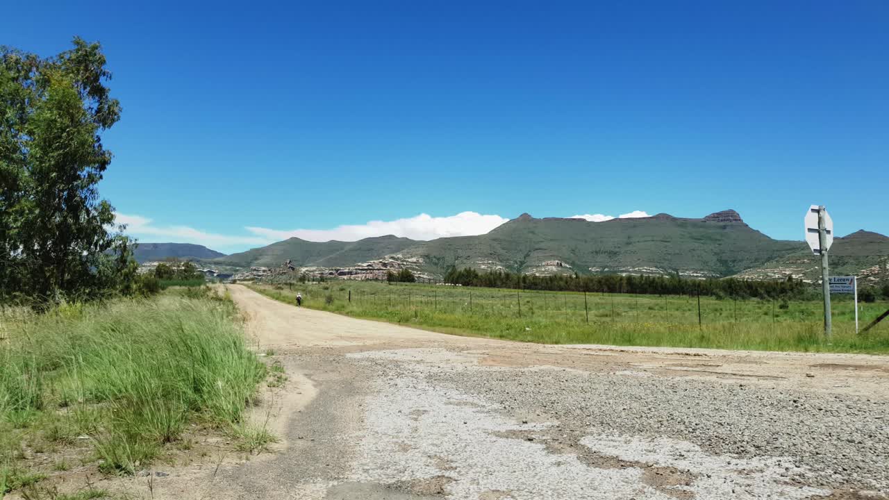 R712 road outside Clarens town in Free-state province South Africa with cars and motorbike traffic traveling past on vacation in Moluti Mountains.